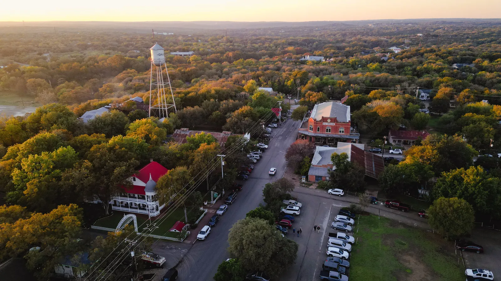 An aerial view of a town's water tower and streets, highlighting New Braunfels' civic infrastructure.