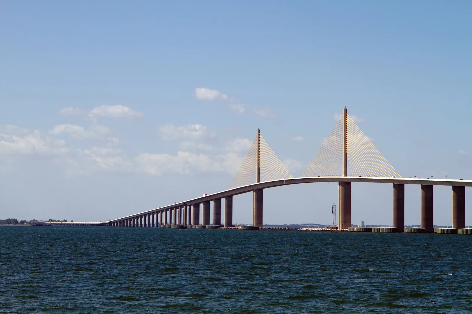 Cable-stayed Sunshine Skyway Bridge spanning open water under a clear sky.